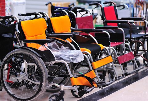 Several wheelchairs sit in a row Durable medical equipment